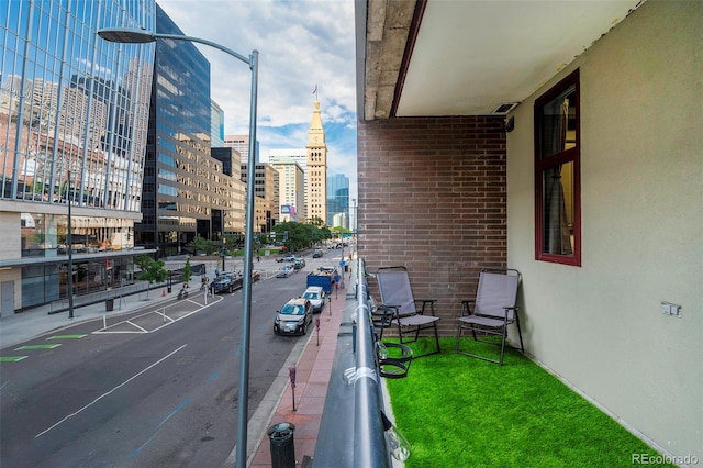 view of road with a view of city, curbs, street lighting, and sidewalks