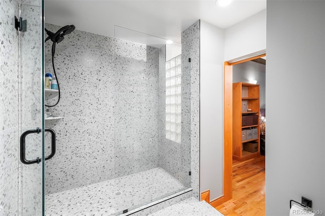 bathroom featuring a stall shower and wood finished floors