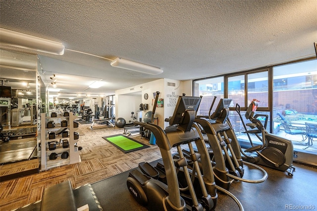 workout area featuring a textured ceiling and light colored carpet