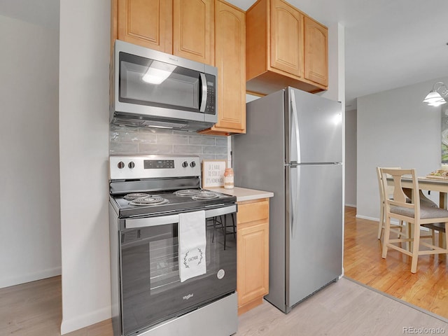 2797 S Newton Way, Denver, CO 80236 - kitchen with stainless steel appliances, light wood-style floors, light brown cabinetry, and backsplash