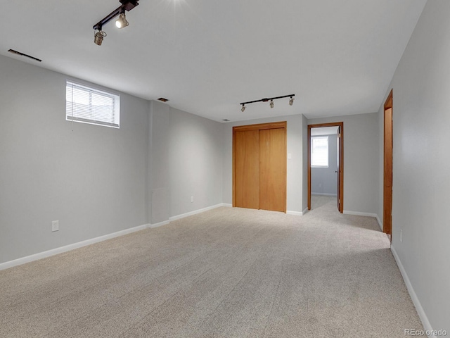 2797 S Newton Way, Denver, CO 80236 - unfurnished room featuring rail lighting and light carpet
