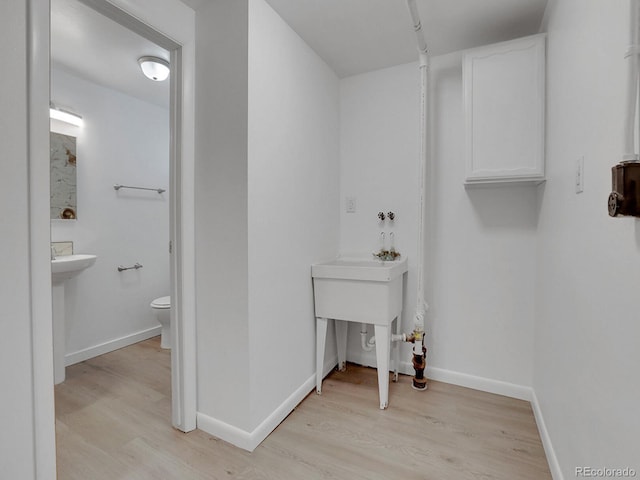 2797 S Newton Way, Denver, CO 80236 - laundry area with light wood-style flooring and baseboards