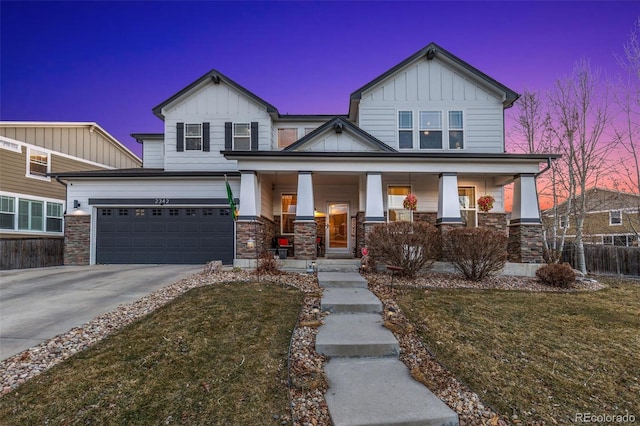 craftsman house featuring a porch, a garage, driveway, stone siding, and board and batten siding