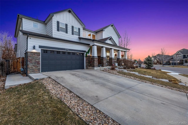 craftsman-style house featuring covered porch, a garage, concrete driveway, stone siding, and board and batten siding