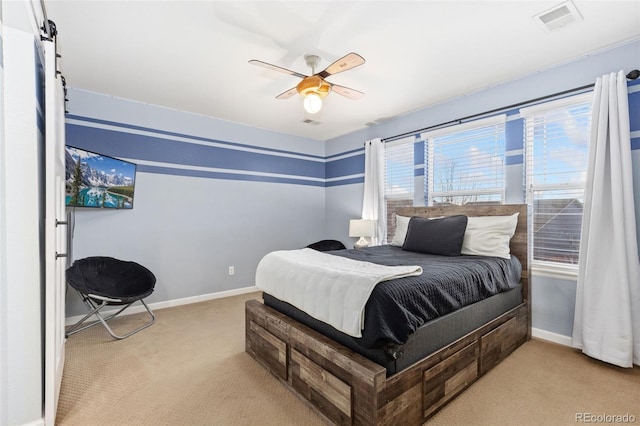 carpeted bedroom featuring a ceiling fan, visible vents, and baseboards