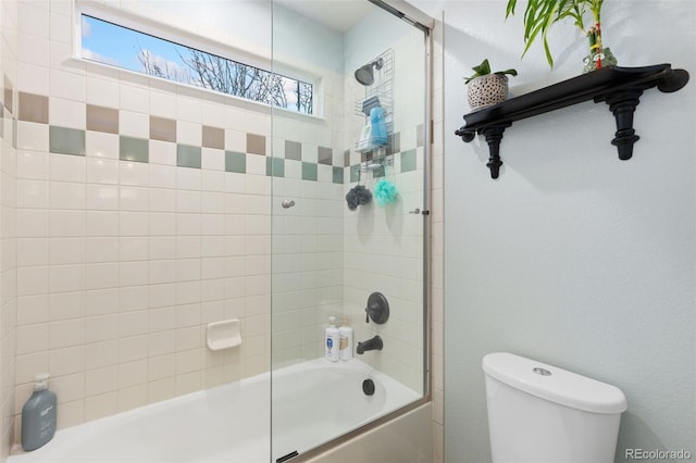 full bathroom with combined bath / shower with glass door and toilet