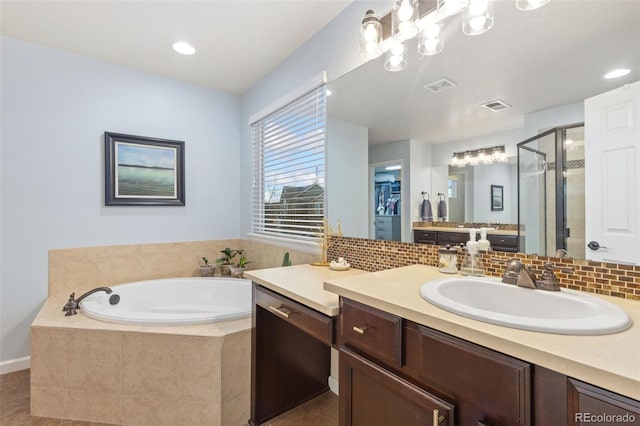 full bath featuring a bath, a shower stall, visible vents, and decorative backsplash