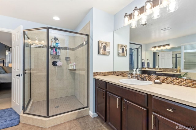 bathroom with a stall shower, visible vents, ensuite bathroom, tile patterned flooring, and backsplash