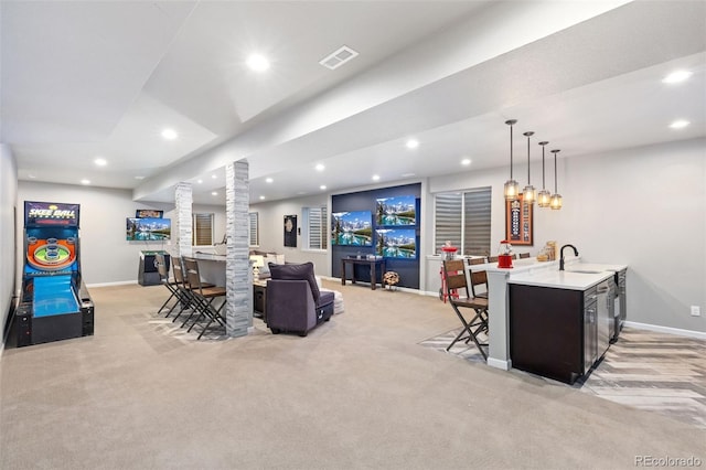 living area with decorative columns, recessed lighting, visible vents, wet bar, and baseboards