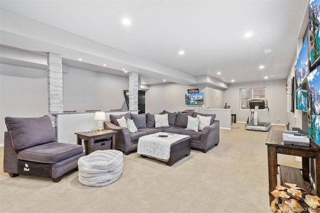 living room with recessed lighting, light carpet, and baseboards