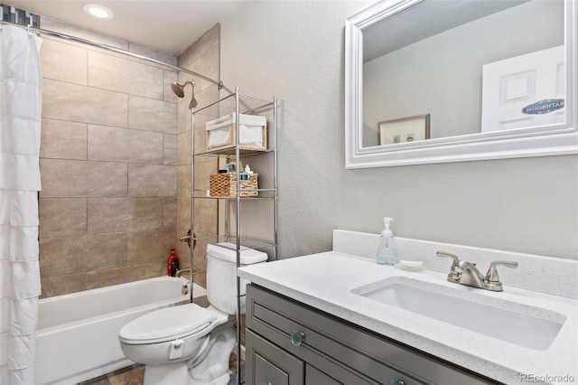 full bathroom featuring shower / bath combo, vanity, and toilet