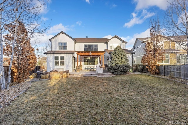 rear view of property with a fenced backyard, a lawn, and a patio