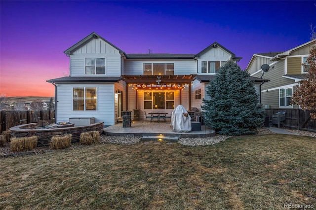 back of property with board and batten siding, a lawn, a patio, fence, and a pergola