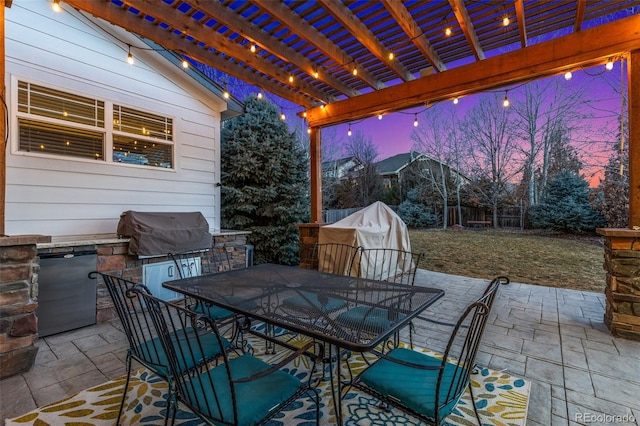 patio terrace at dusk with area for grilling, an outdoor kitchen, a pergola, and outdoor dining space