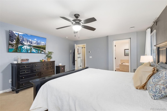 bedroom with light colored carpet, a ceiling fan, baseboards, visible vents, and ensuite bath