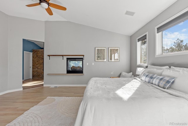 bedroom featuring lofted ceiling, light wood-type flooring, and ceiling fan