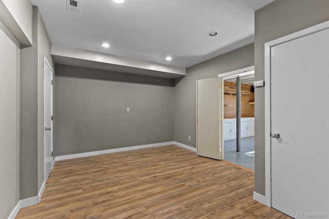 empty room with hardwood / wood-style flooring