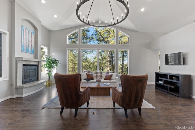 living room with high vaulted ceiling, dark hardwood / wood-style flooring, and a notable chandelier