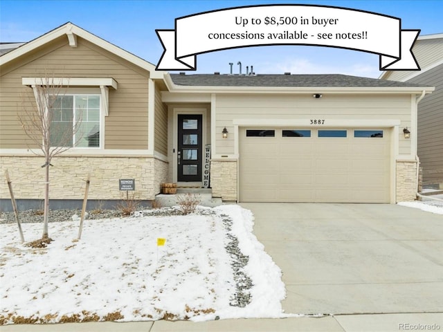 view of front of home featuring an attached garage, stone siding, and driveway