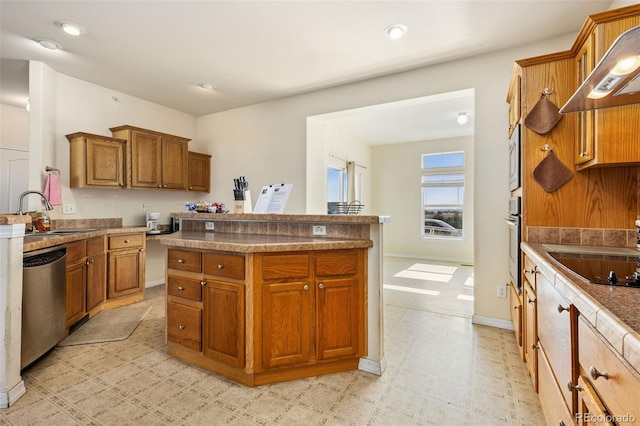 4241 Meadowlark Rd, Fort Lupton, CO 80621 - kitchen featuring stainless steel appliances, wall chimney exhaust hood, brown cabinetry, a center island, and recessed lighting