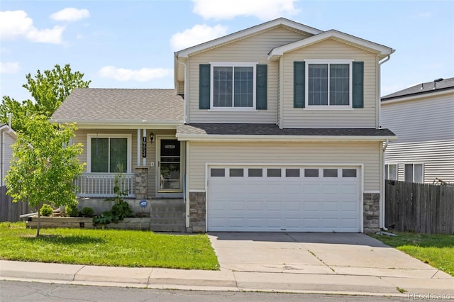 19524 Montview Dr, Aurora, CO 80011 - view of front of property with stone siding, concrete driveway, covered porch, and an attached garage
