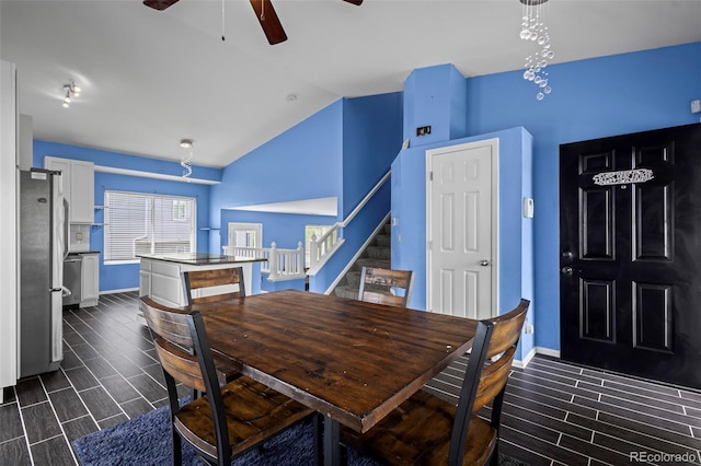 19524 Montview Dr, Aurora, CO 80011 - dining room featuring vaulted ceiling, a ceiling fan, wood tiled floors, and stairway