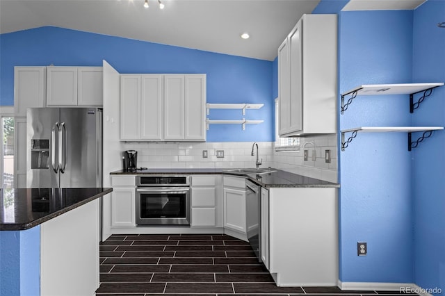 19524 Montview Dr, Aurora, CO 80011 - kitchen with appliances with stainless steel finishes, open shelves, lofted ceiling, backsplash, and wood finish floors