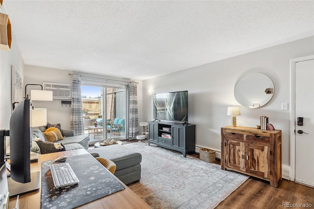 2835 S Monaco Pkwy Unit 1-103, Denver, CO 80222 - living room with a wall mounted air conditioner, a textured ceiling, and wood finished floors