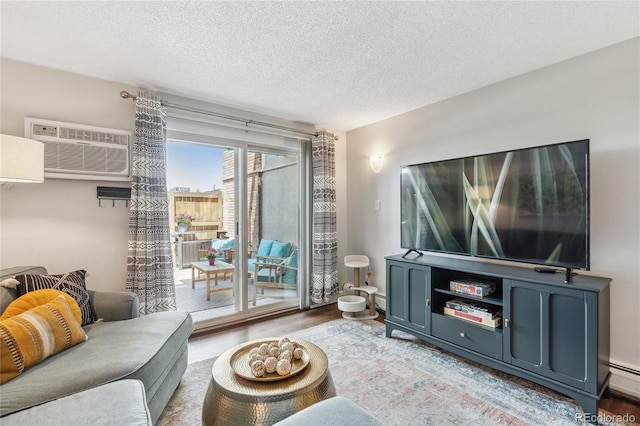 2835 S Monaco Pkwy Unit 1-103, Denver, CO 80222 - living area with wood finished floors, a wall mounted AC, and a textured ceiling