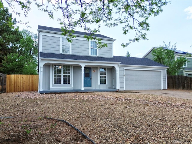 2726 Dickens Dr, Colorado Springs, CO 80916 - traditional home featuring a porch, a garage, driveway, and roof with shingles