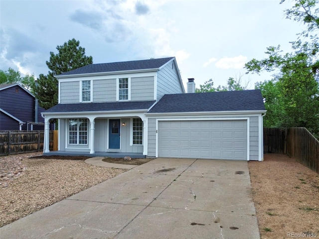 2726 Dickens Dr, Colorado Springs, CO 80916 - traditional-style home featuring concrete driveway, a garage, covered porch, a chimney, and roof with shingles