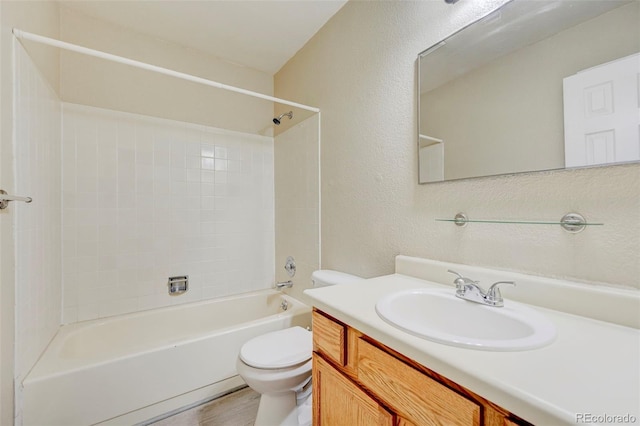 2726 Dickens Dr, Colorado Springs, CO 80916 - bathroom featuring toilet, bathing tub / shower combination, vanity, a textured wall, and wood finished floors