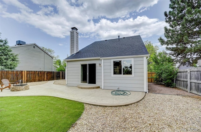 2726 Dickens Dr, Colorado Springs, CO 80916 - back of property with an outdoor fire pit, a patio area, roof with shingles, and a chimney