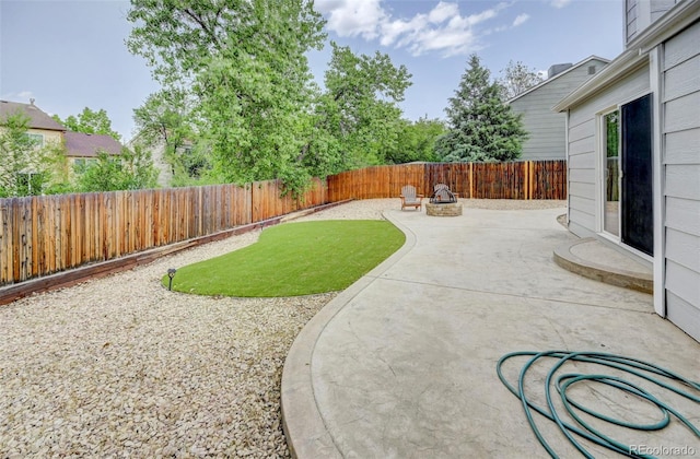 2726 Dickens Dr, Colorado Springs, CO 80916 - fenced backyard with a fire pit and a patio