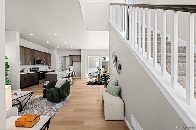 20871 E 60th Ave, Aurora, CO 80019 - living room featuring light wood finished floors, recessed lighting, and baseboards