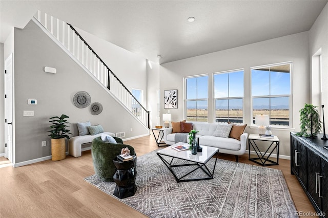 20871 E 60th Ave, Aurora, CO 80019 - living area with stairs, wood finished floors, and baseboards