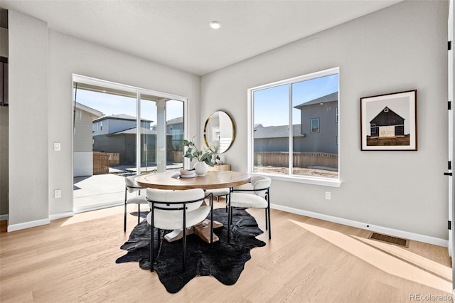 20871 E 60th Ave, Aurora, CO 80019 - dining space featuring healthy amount of natural light, wood finished floors, and baseboards
