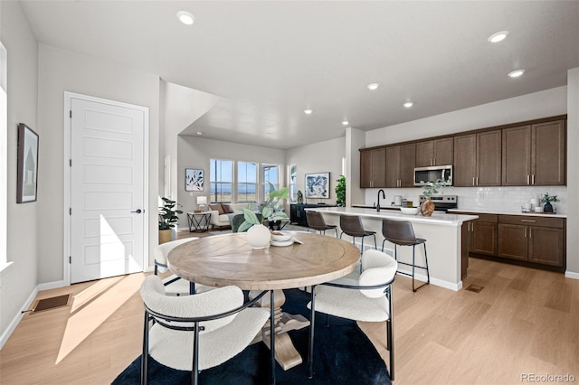 20871 E 60th Ave, Aurora, CO 80019 - dining room with light wood-type flooring, recessed lighting, and baseboards