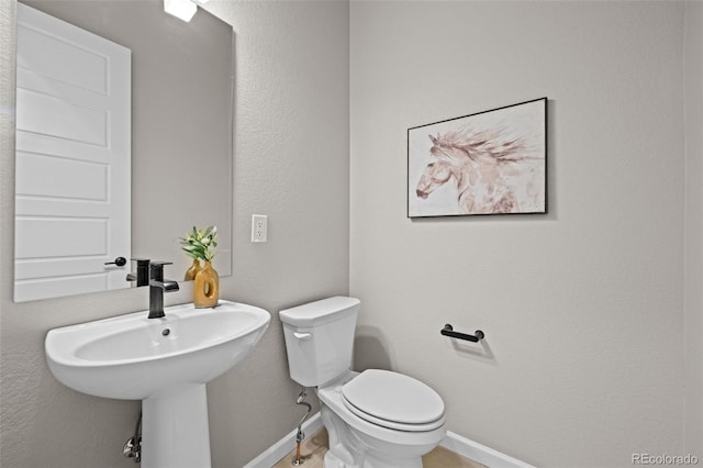 20871 E 60th Ave, Aurora, CO 80019 - half bath featuring baseboards, toilet, and a sink