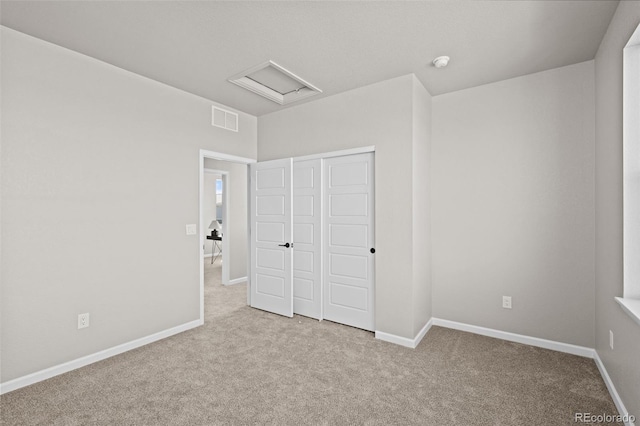 20871 E 60th Ave, Aurora, CO 80019 - unfurnished bedroom featuring carpet floors, a closet, baseboards, and attic access