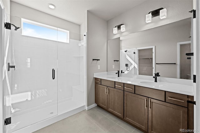 20871 E 60th Ave, Aurora, CO 80019 - full bath featuring a stall shower, double vanity, tile patterned floors, baseboards, and a walk in closet