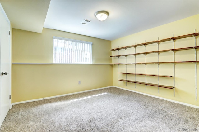 empty room featuring baseboards, carpet flooring, and visible vents