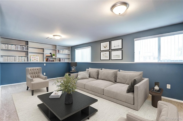 carpeted living area with baseboards