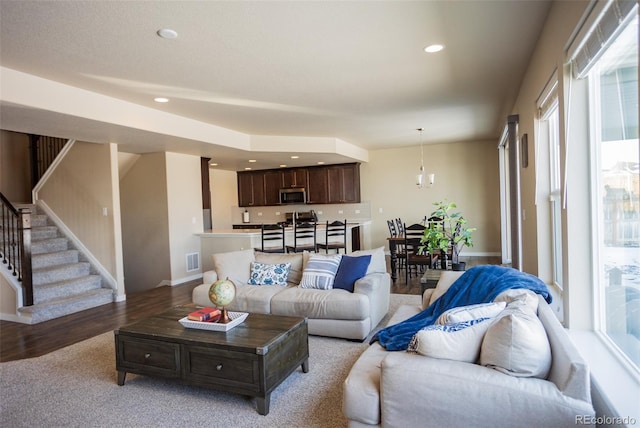 living room with visible vents, light wood-style flooring, recessed lighting, stairway, and baseboards