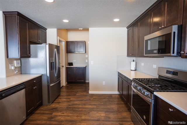 kitchen featuring dark wood-style floors, light countertops, dark brown cabinets, appliances with stainless steel finishes, and backsplash