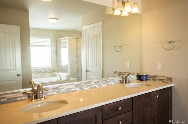 full bathroom with a sink, a tub to relax in, double vanity, and a shower stall