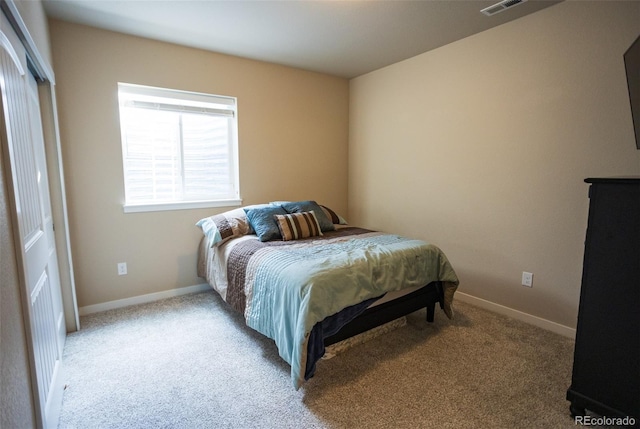 carpeted bedroom featuring baseboards