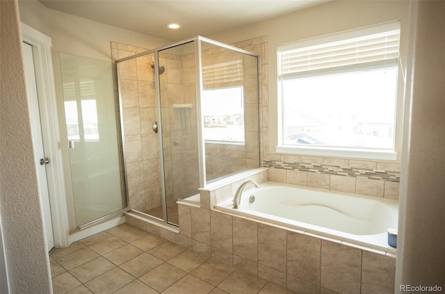 full bathroom featuring tile patterned flooring, a shower stall, and a garden tub