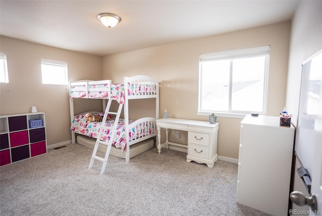 bedroom featuring baseboards and light carpet