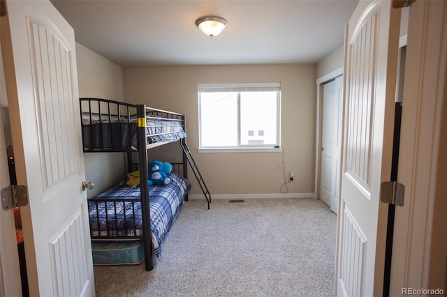 bedroom with carpet flooring and baseboards